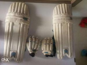 Pair Of White Shin Guards And White Gloves