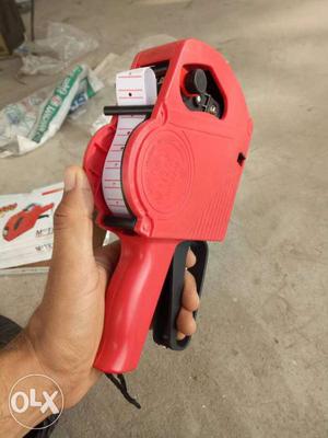 Red And Black Handheld Measuring Tool