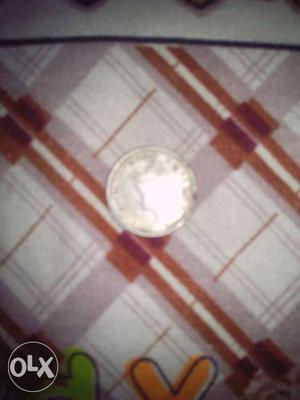 76 year old half rupee coin