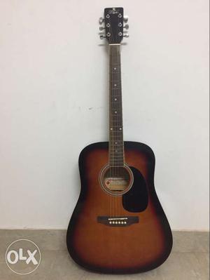 Guitar with tunar 1 year use brwon and black with