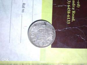 It is a old silver one ruppee coin and tambha