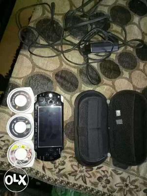 Black Sony PSP, UMD, And Bag