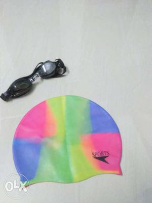 Black Swimming Goggles And Pink-and-blue Swimming Cap