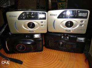Two Silver-and-black Nikon Cameras