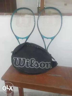 Two Teal-and-black Wilson Tennis Rackets