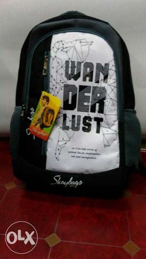 Now White And Black Backpack With WANDERLUST Text