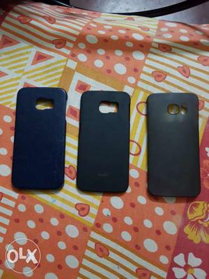 Two Black And One Blue Smartphone Cases
