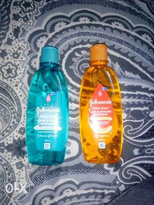 Two Blue And Orange Jonhson's Bottles