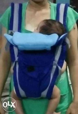 White and blue baby carrier bag.