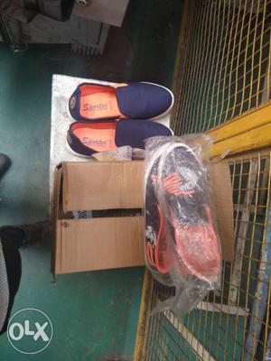 Two Pairs Of Black And Blue Slip On Shoes With Boxes
