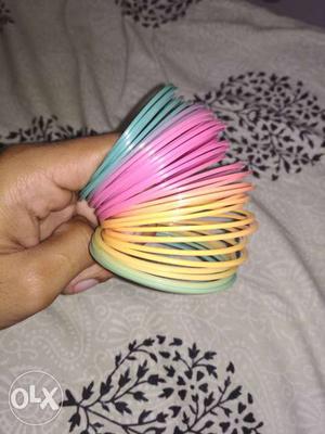 Pink, Yellow, Teal, And Blue Slinky Toy