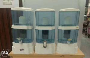 Three White-and-blue Water Purifier Dispensers