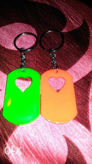 Two Oval Orange And Green Plastic Heart Keychains