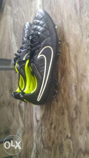 Black-and-green Nike Cleats