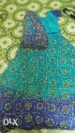 Green and blue lehenga with work throughout.
