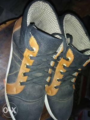 Pair Of Black And Brown Leather High-top Shoes