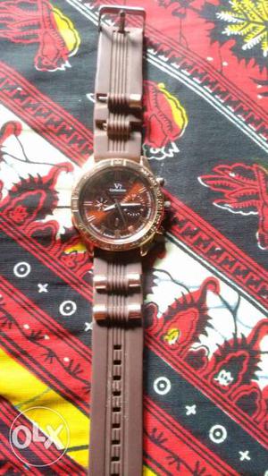 Round Silver Chronograph Watch With Brown Band