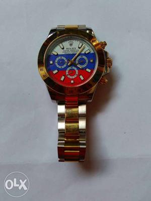 Round White-blue-and-red- Faced Rolex Chronograph Watch With
