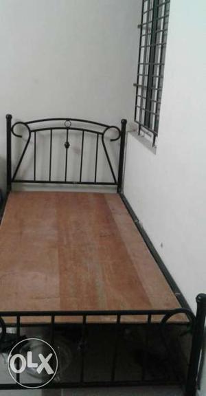An iron metal cot almost like new with mattress for