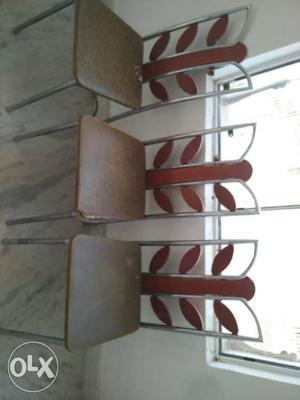 Three Gray Steel Frame Brown Wooden Chairs