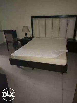 White Mattress And Brown Wooden Bed Frame