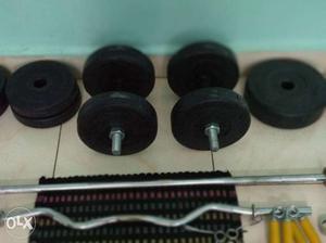 Two Black Adjustable Dumbbells With Weight Plates