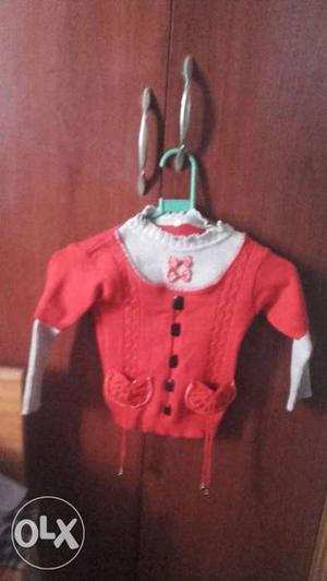 Red and grey pullover for baby girl of three to
