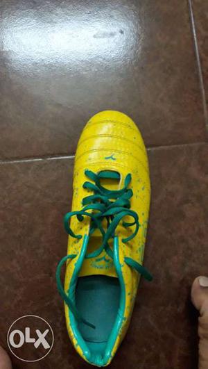 Unpaired Yellow And Green Cleats