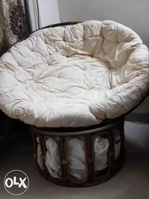 An easy comfortable round cozy cane chair with