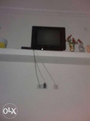 Black Flat Screen TV; White Wooden TV Stand