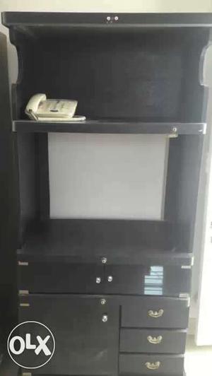 Black Tv wooden stand with multiple compartment.