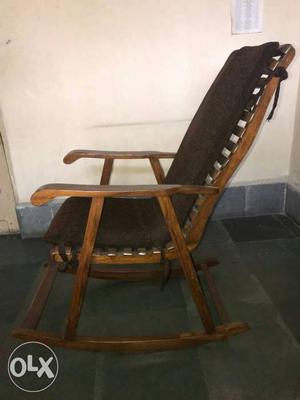 Rocking chair made of teak wood with the cushion