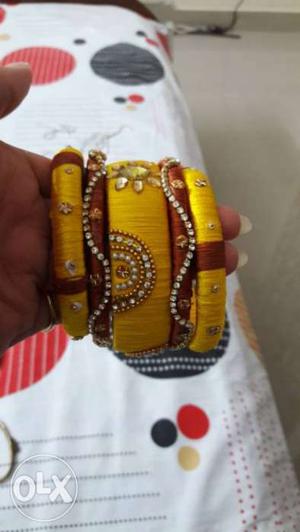Several Red And Yellow Silk Thread Bangles