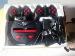 Black Game Console With Two Controllers