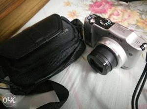 Silver Canon Camera With Bag