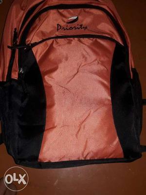 Orange And Black Priority Backpack
