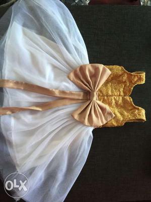 Baby's Gold And White Sleeveless Dress With Ribbon
