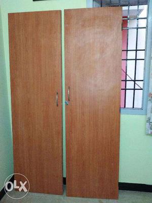 A pair of wooden doors from a wall mounted cup board for