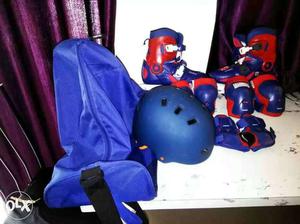 Blue-and-red Ski Boots, Knee Pads, Elbow Pads, And Helmet