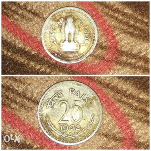 Round Gold-colored 25 Indian Paise Coin