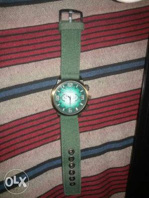 Round Green And Gold-colored Chronograph Watch With Green
