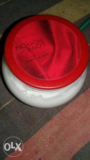 Round Red And White Labeled Bottle
