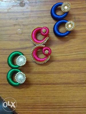 Three Pairs Of Pink, Green, And Blue Jhumka Earrings
