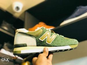 Unpaired Green-and-brown New Balance 574