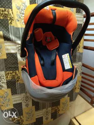Baby's Orange And Black Car Seat Carrier
