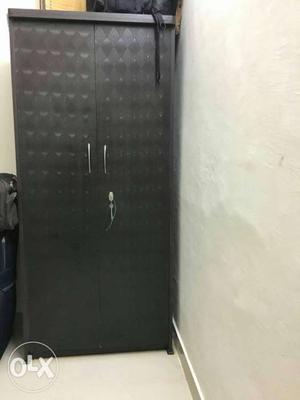 Black wooden cupboard up for sale. 2 months used.