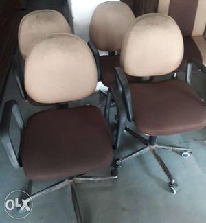 Four Brown And Beige Rolling Chairs