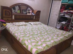 Green And Pink Floral Printed Bed Mattress With Brown Wooden