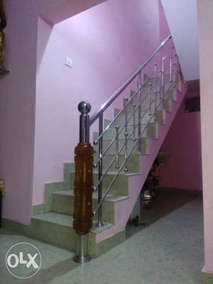 Pink And Gray Concrete Stair With Gray Metal Rails