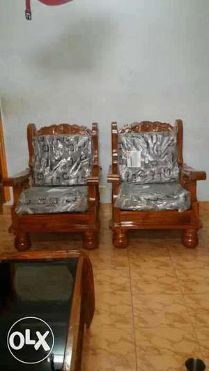 Two Brown Wooden Base Gray Padded Armchairs